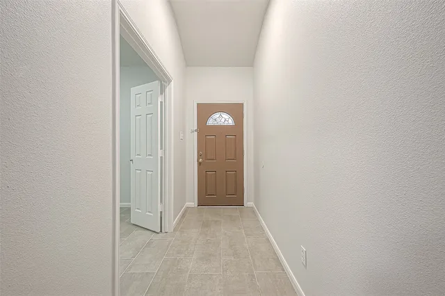 a view of a hallway with a wooden door