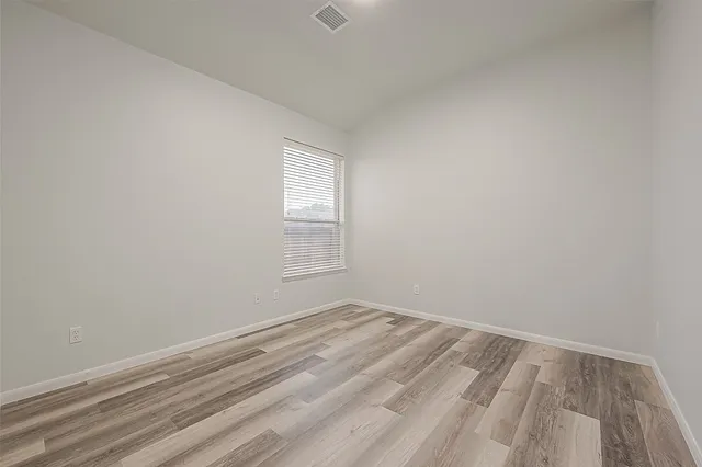 a view of a room with wooden floor