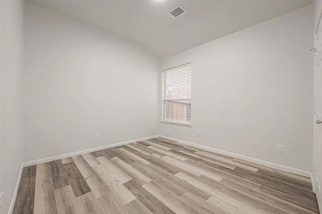 a view of room with wooden floor