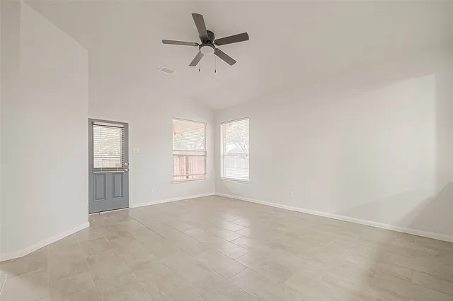 a view of empty room with ceiling fan