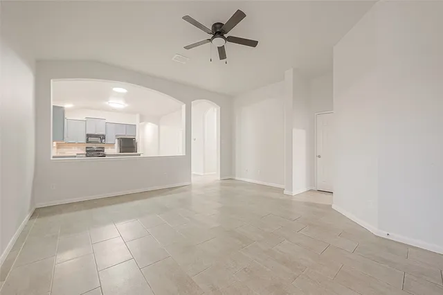 an empty room with a empty space and a ceiling fan