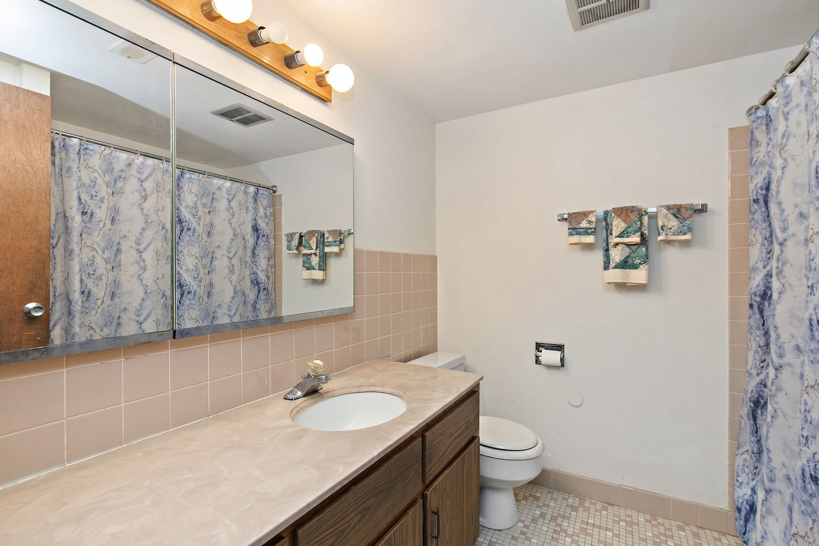 5s100 Pebblewood Lane, Unit E6 Naperville, IL 60563 - Photo 14 of 18 a bathroom with a granite countertop sink a toilet and a mirror