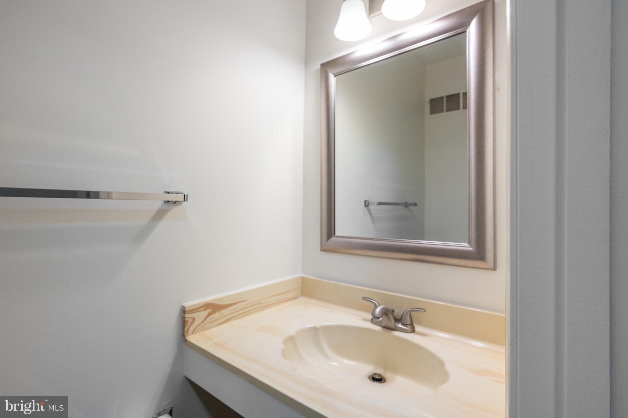 2436 Windbreak Drive Alexandria, VA 22306 - Photo 11 of 36 a bathroom with a sink and a mirror