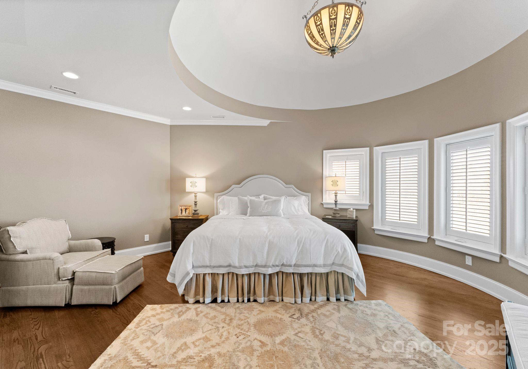 4004 Channel Point Lane Denver, NC 28037 - Photo 21 of 48 a spacious bedroom with a bed and a chandelier