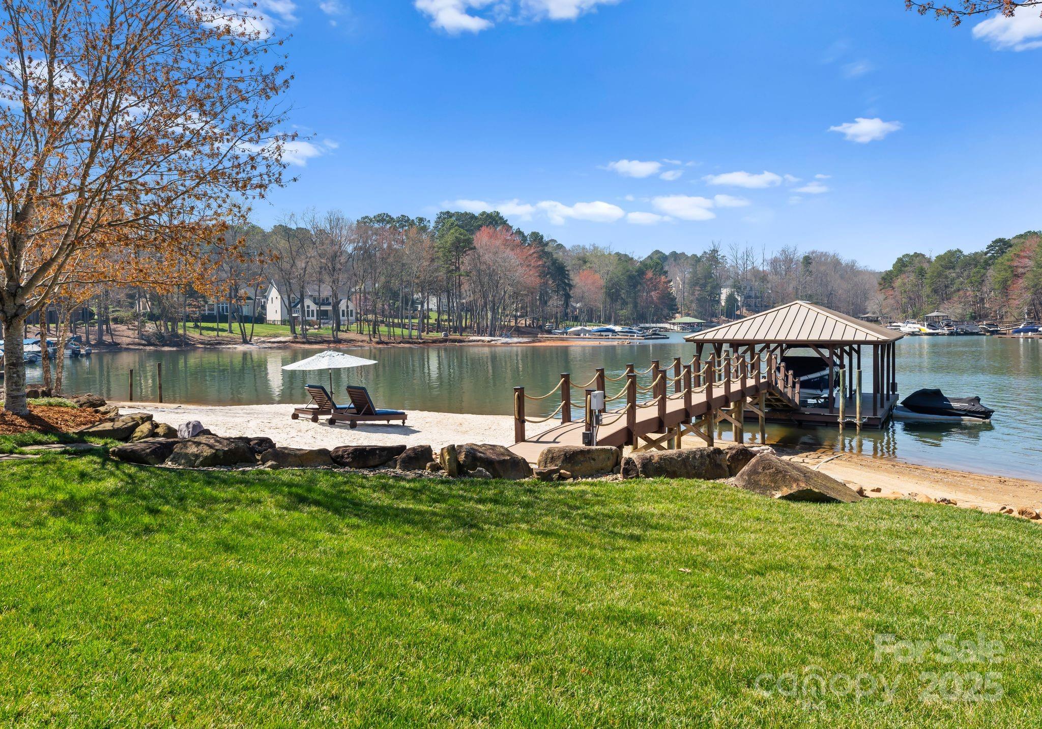 4004 Channel Point Lane Denver, NC 28037 - Photo 36 of 48 a view of a lake with lawn chairs and a big yard
