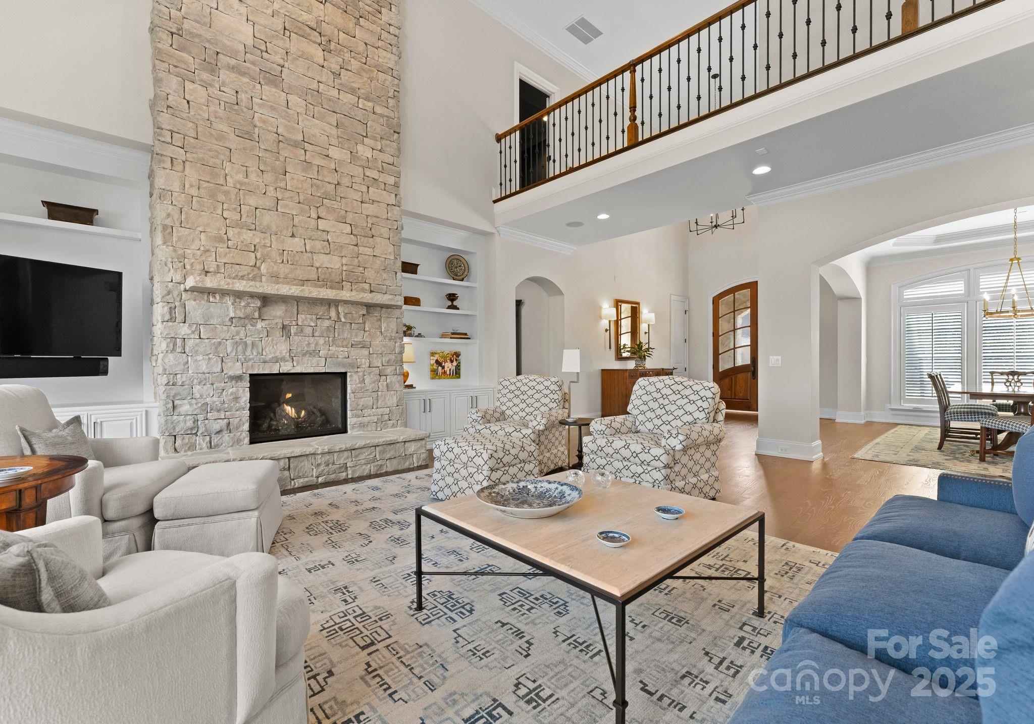 4004 Channel Point Lane Denver, NC 28037 - Photo 4 of 48 a living room with furniture a flat screen tv and a fireplace