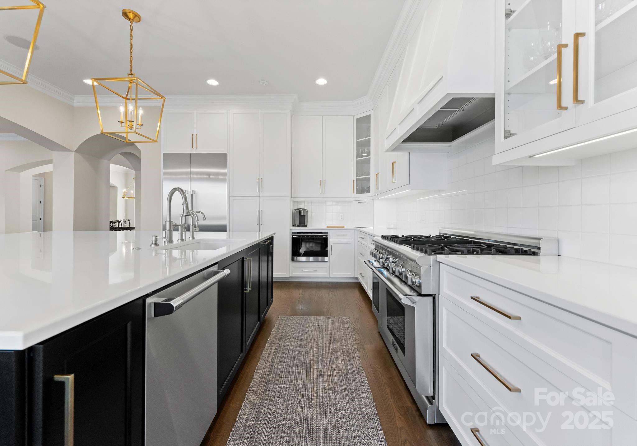 4004 Channel Point Lane Denver, NC 28037 - Photo 6 of 48 a kitchen with kitchen island granite countertop lots of counter top space and stainless steel appliances