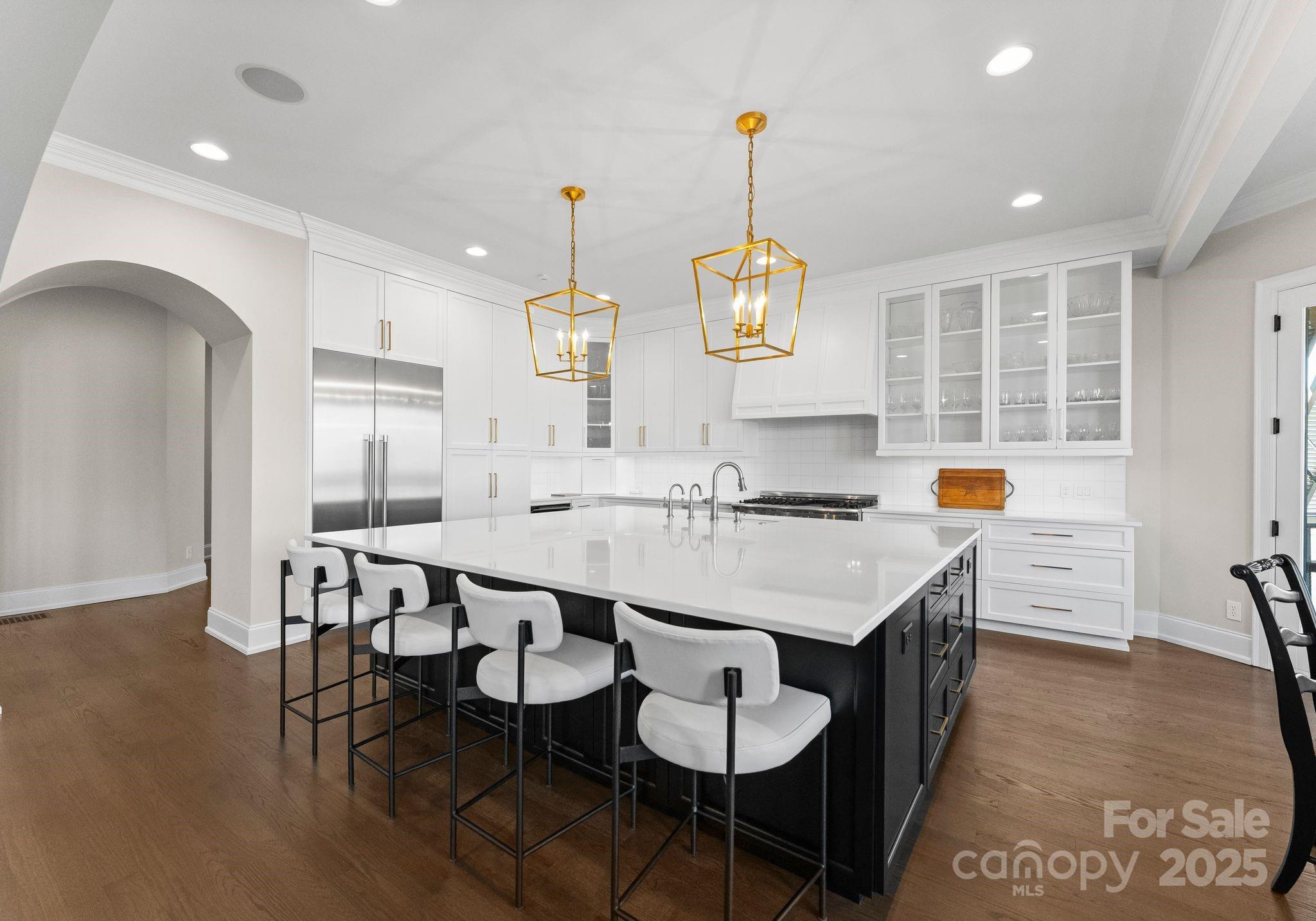 4004 Channel Point Lane Denver, NC 28037 - Photo 7 of 48 a kitchen with a dining table chairs and white cabinets