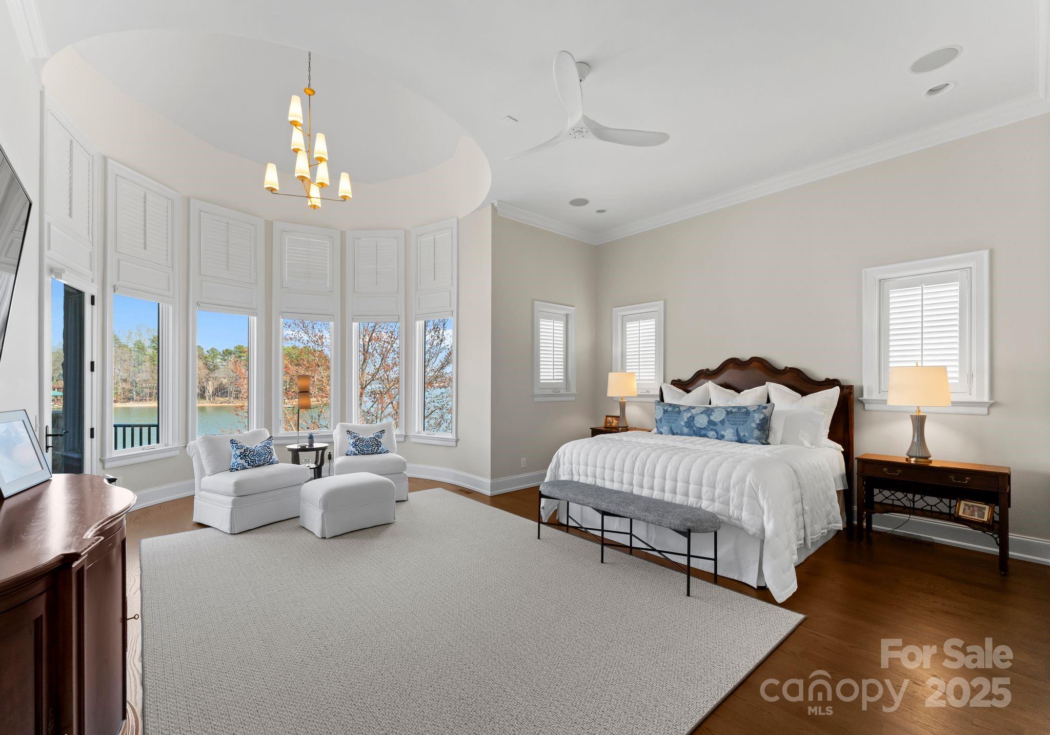 4004 Channel Point Lane Denver, NC 28037 - Photo 9 of 48 a spacious bedroom with two beds and a chandelier