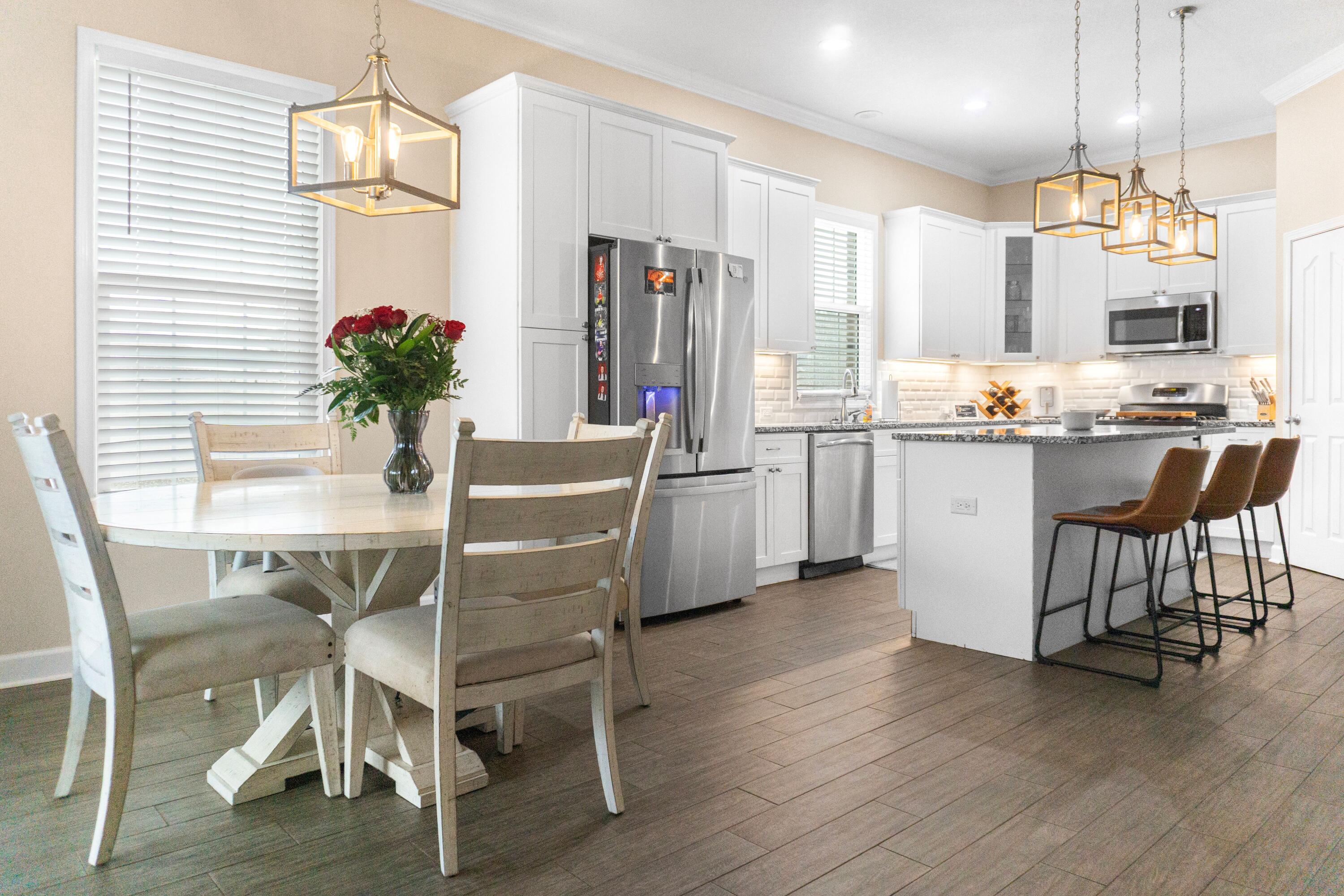 2902 Short Tail Court Panama City, FL 32405 - Photo 12 of 46 a view of a dining room with furniture and wooden floor