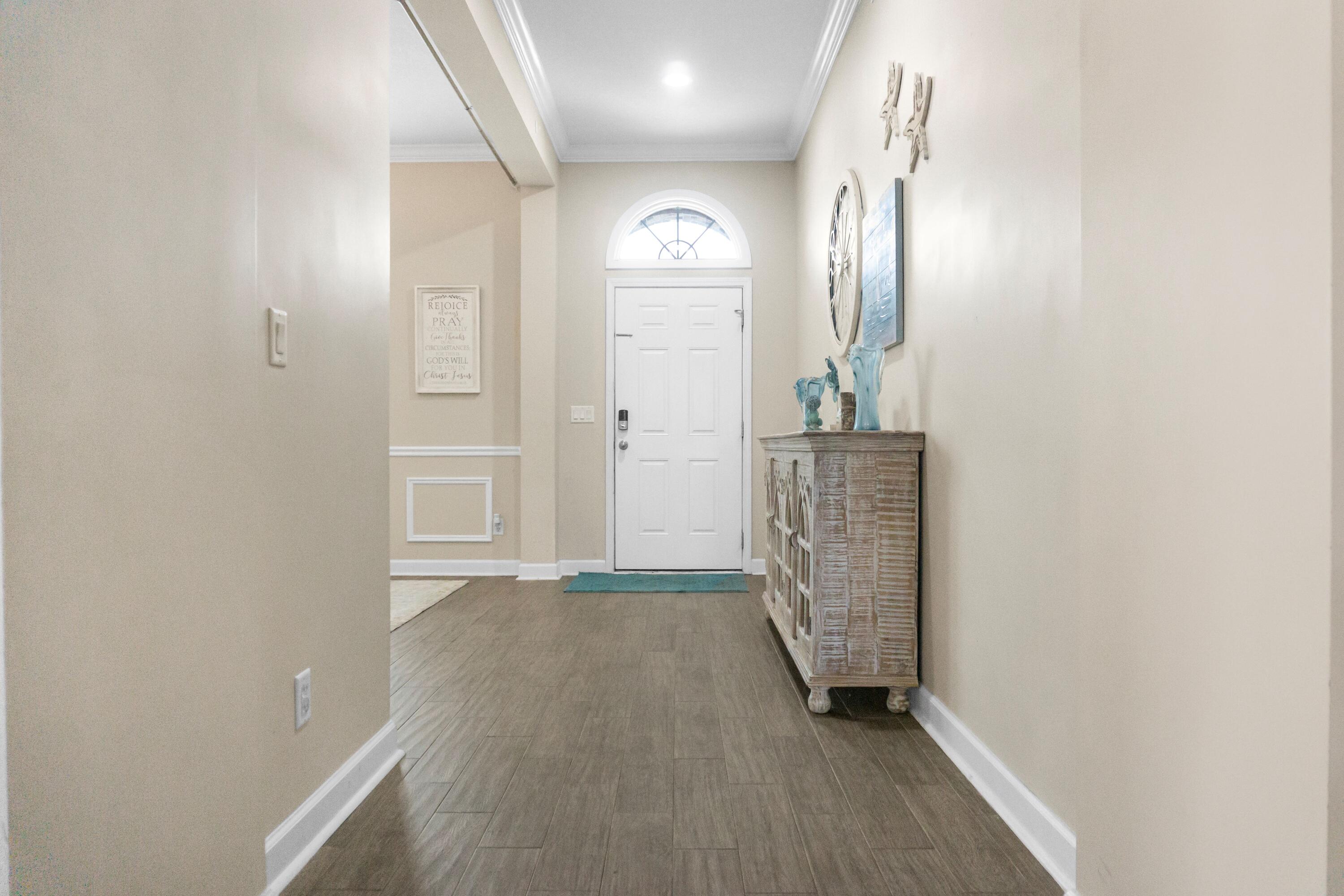 2902 Short Tail Court Panama City, FL 32405 - Photo 19 of 46 an empty room with mirror and a wooden floor