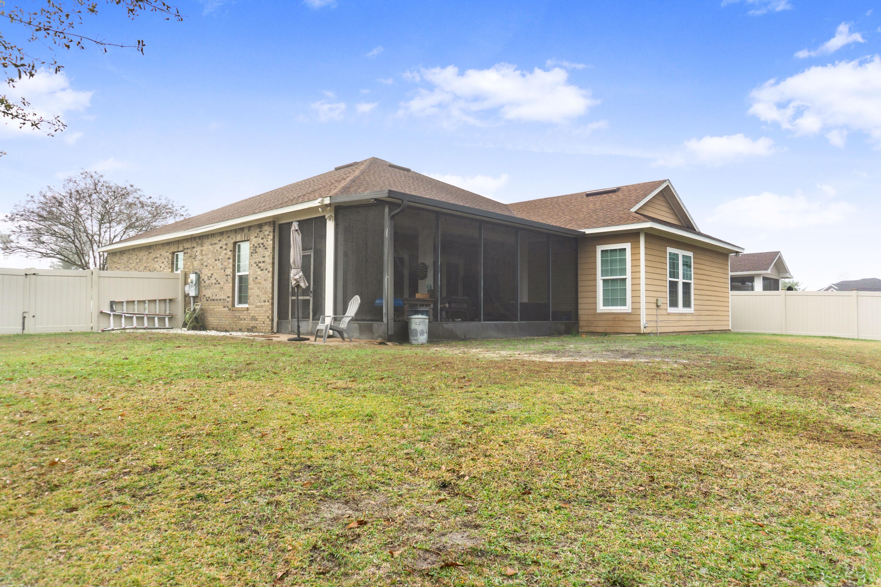 2902 Short Tail Court Panama City, FL 32405 - Photo 2 of 46 a front view of a house with a garden