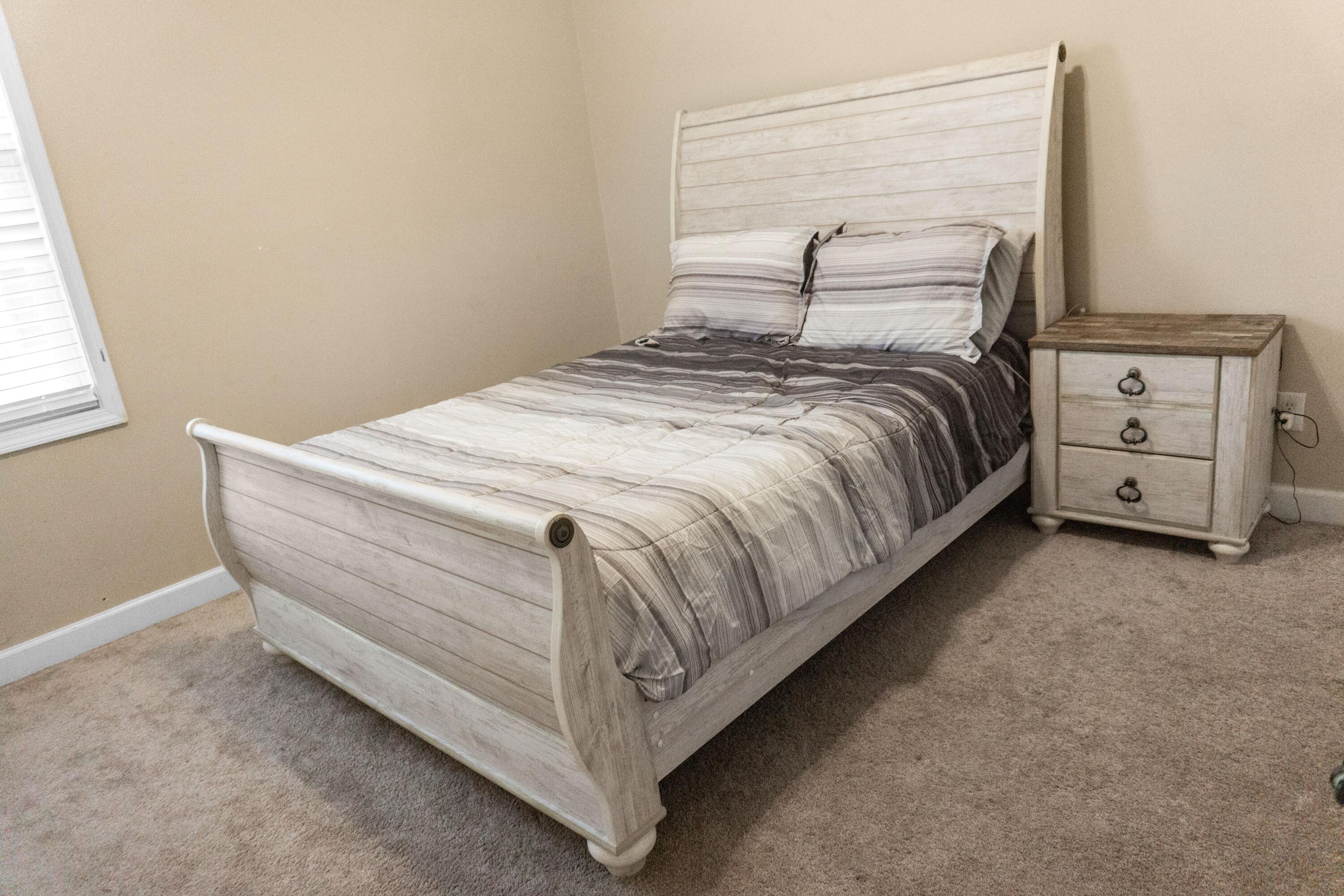 2902 Short Tail Court Panama City, FL 32405 - Photo 30 of 46 a bed sitting in a bedroom next to a window