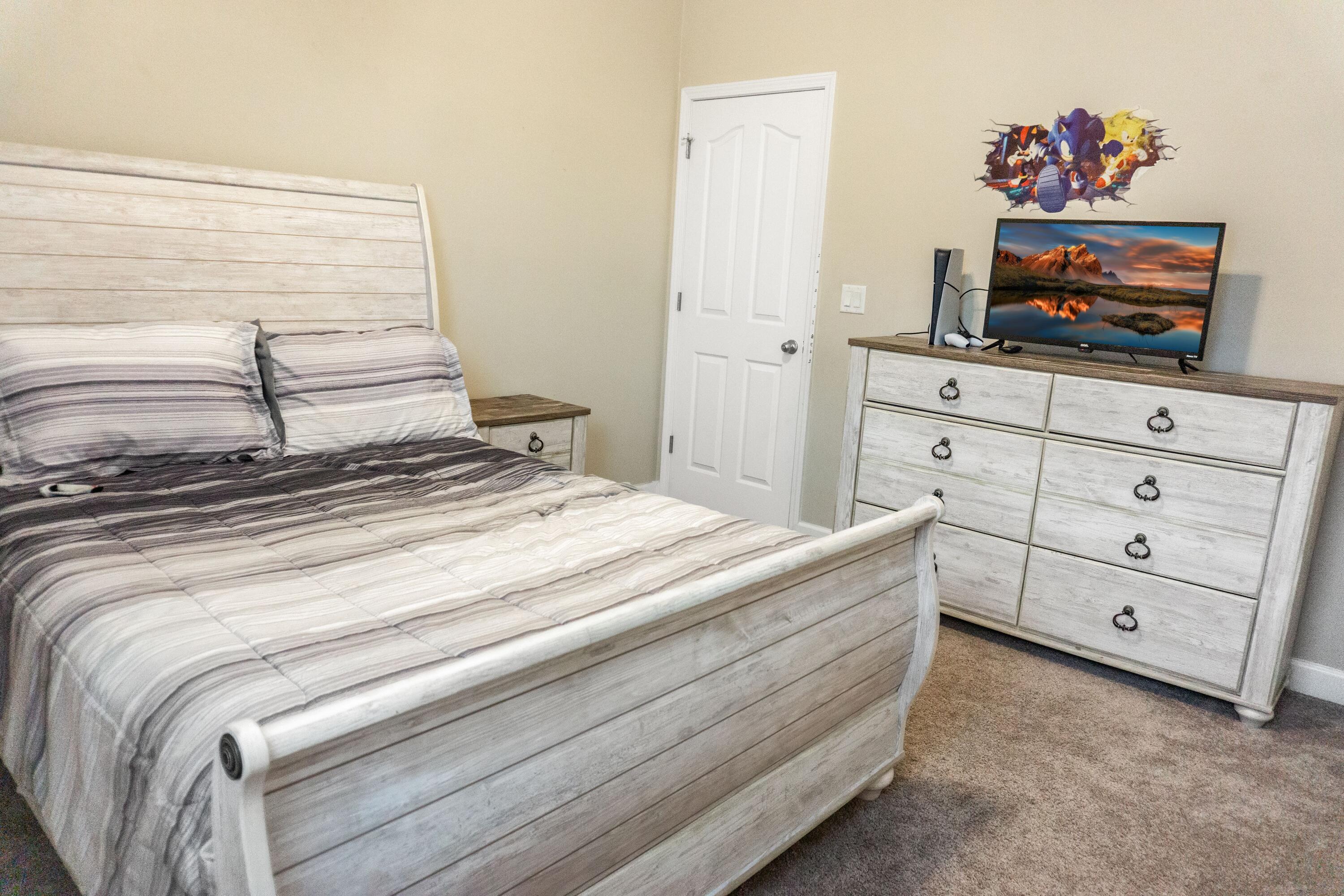 2902 Short Tail Court Panama City, FL 32405 - Photo 31 of 46 a bedroom with a bed and a flat screen tv