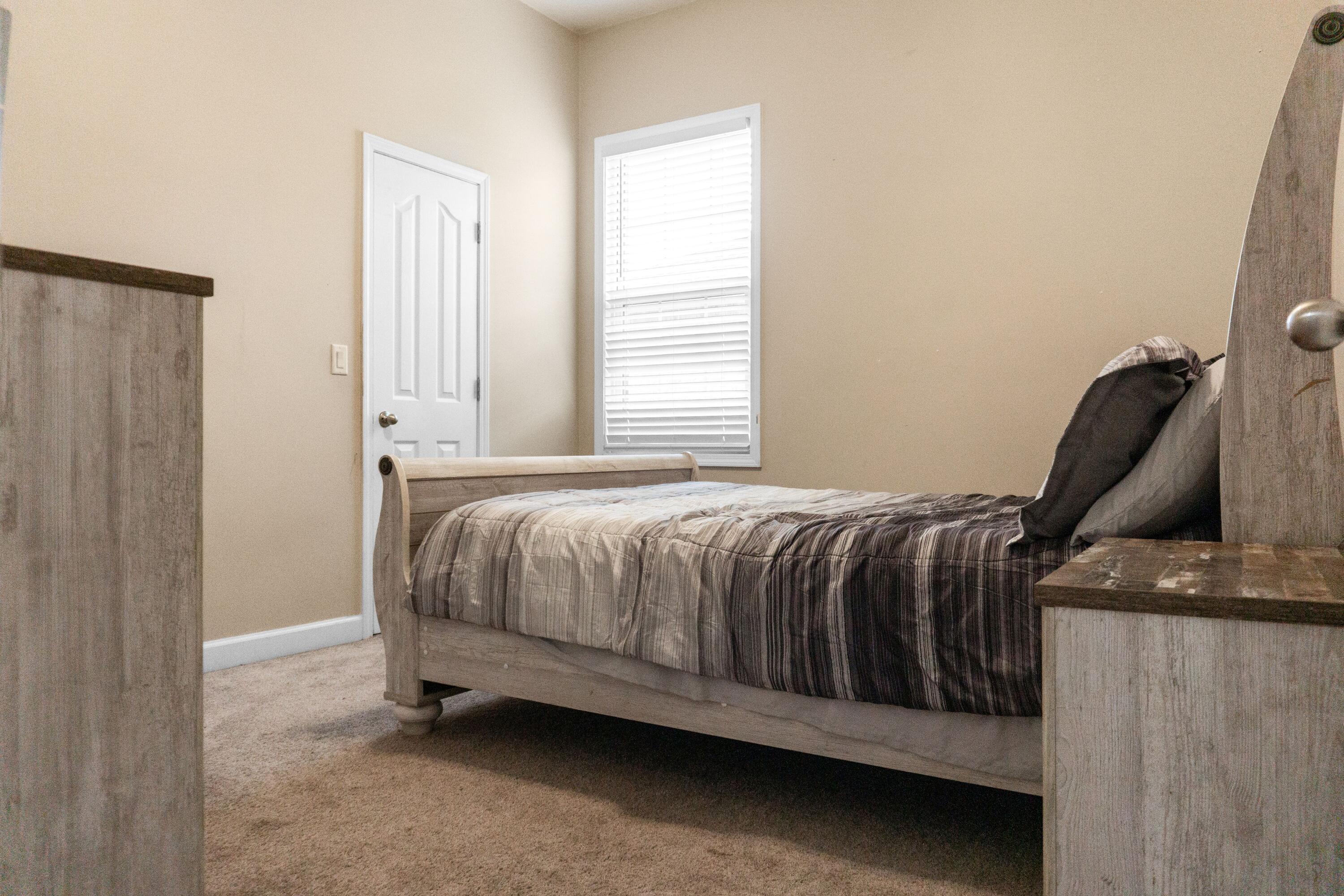 2902 Short Tail Court Panama City, FL 32405 - Photo 32 of 46 a bed sitting in a bedroom next to a window