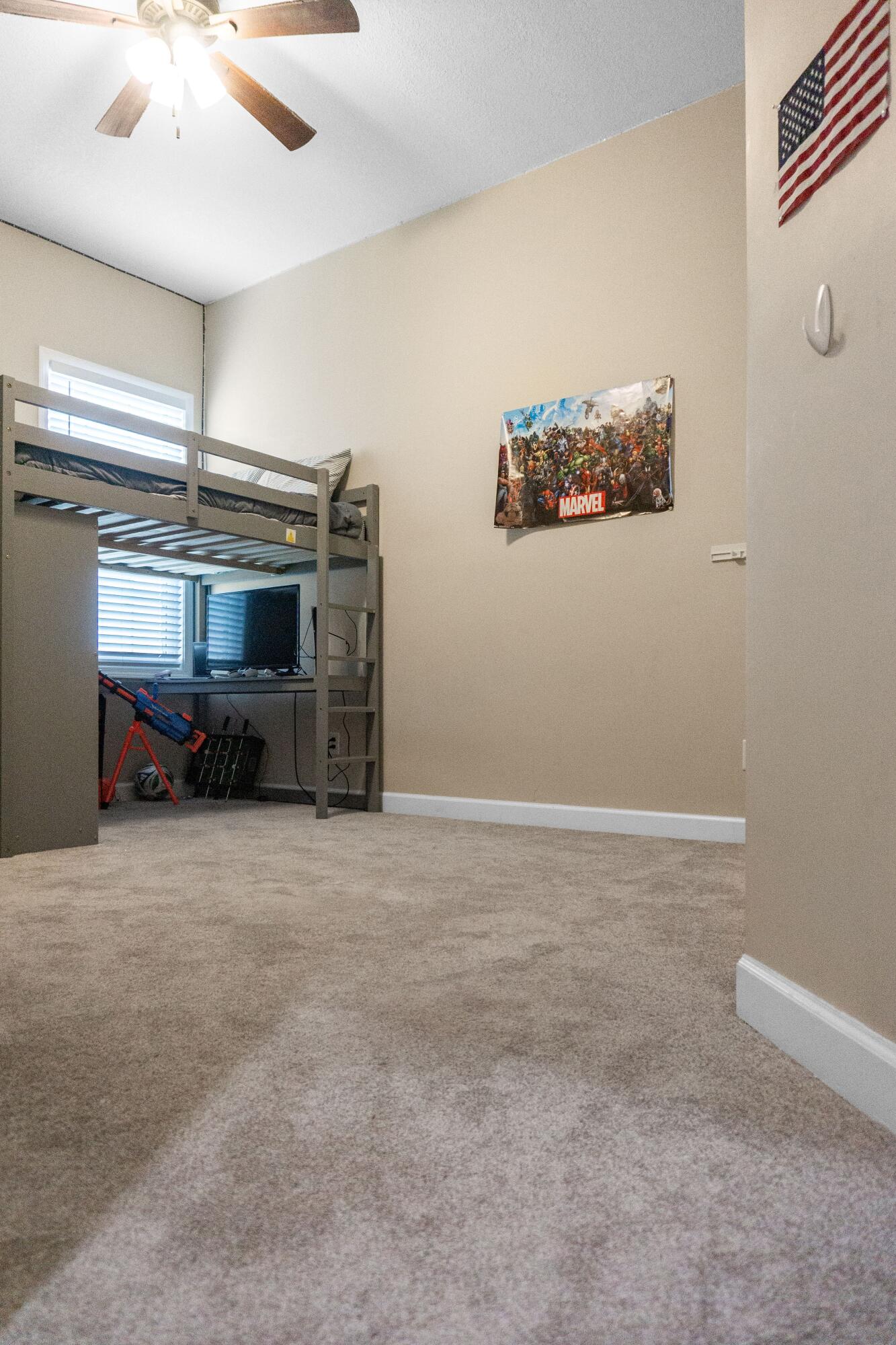 2902 Short Tail Court Panama City, FL 32405 - Photo 33 of 46 a room with a flat screen tv and a ceiling fan