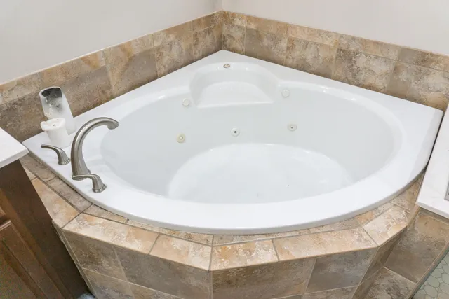 a front view of a house with a garden and trees