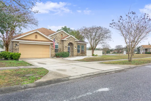 a view of a backyard with a garden and trees