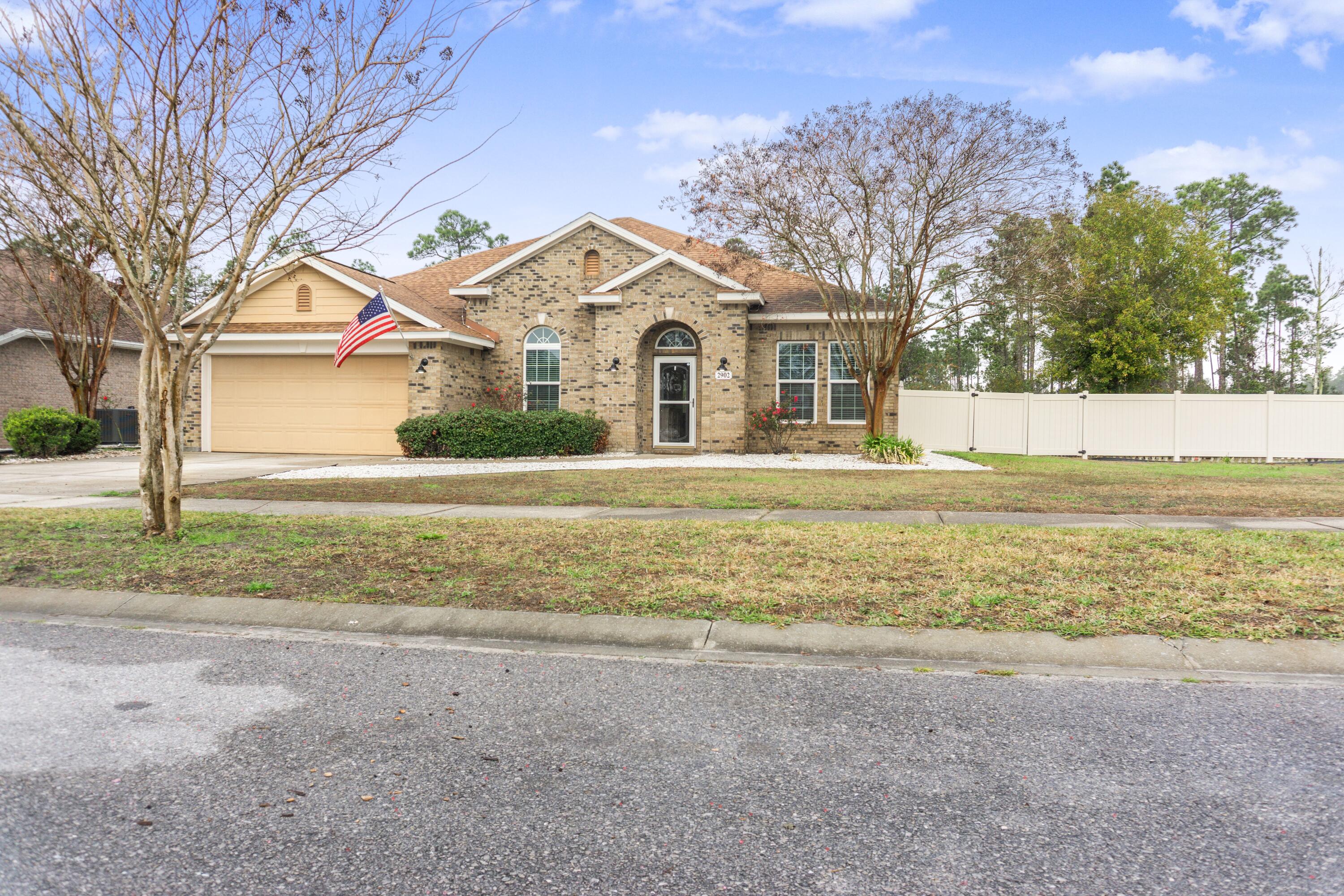 2902 Short Tail Court Panama City, FL 32405 - Photo 43 of 46 a front view of a house with a yard and trees