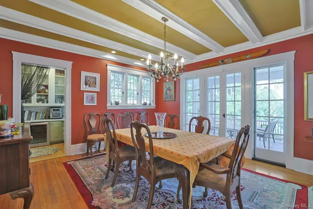 a dining room with furniture a chandelier and wooden floor