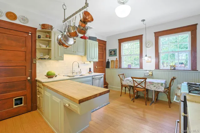 a dining hall with stainless steel appliances granite countertop a sink and a refrigerator