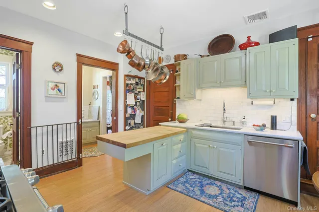 a very nice looking room with a sink a window and cabinets
