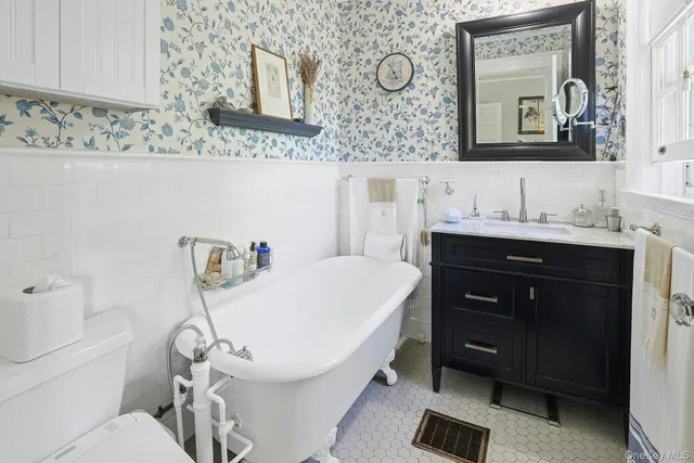 a living room with a bed furniture and a window