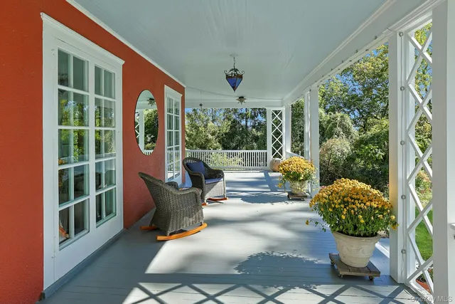a view of a backyard with table and chairs and a large tree