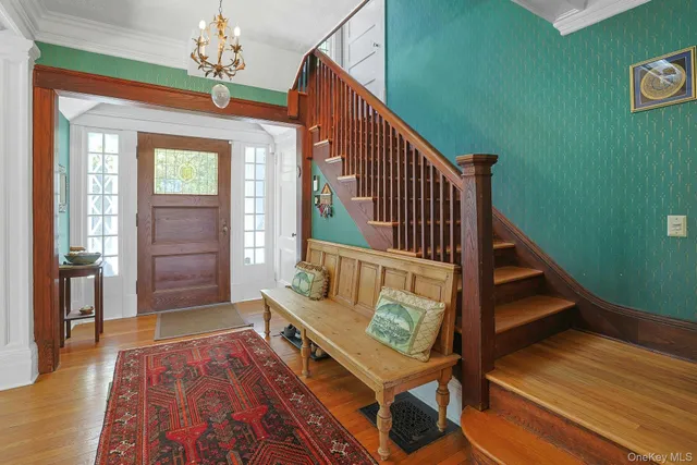 a view of an entryway with wooden floor and stairs