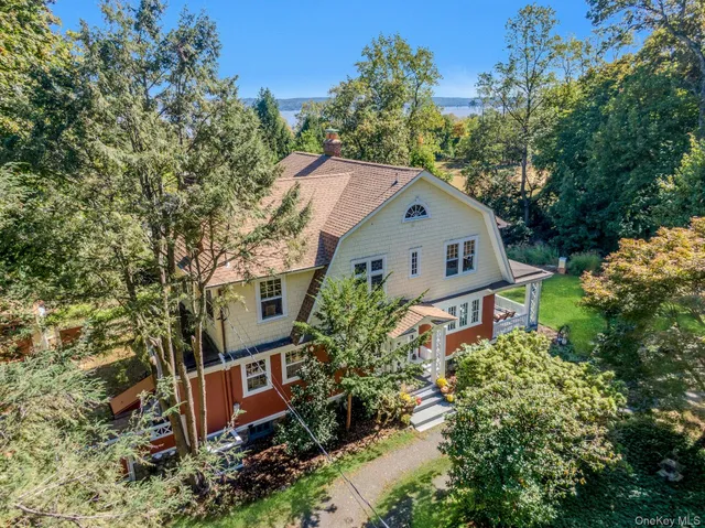 a view of a house with a yard and sitting area
