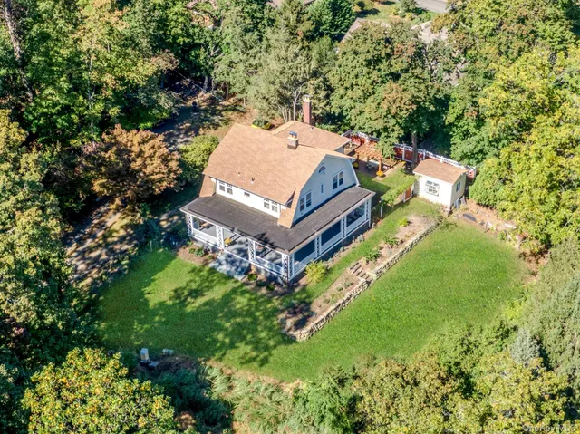 an aerial view of a house with a big yard