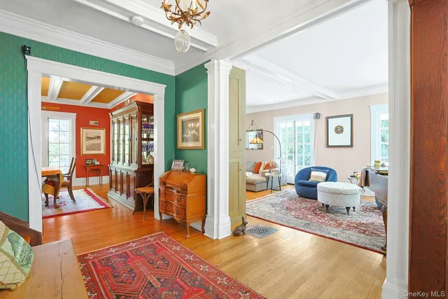 a living room with furniture rug and wooden floor