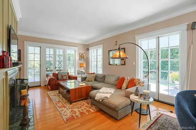 a living room with furniture and a floor to ceiling window