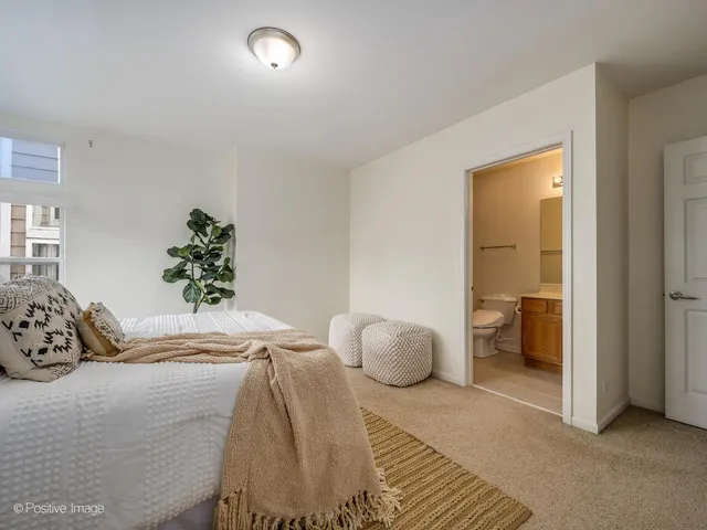 a bedroom with a bed and a large mirror