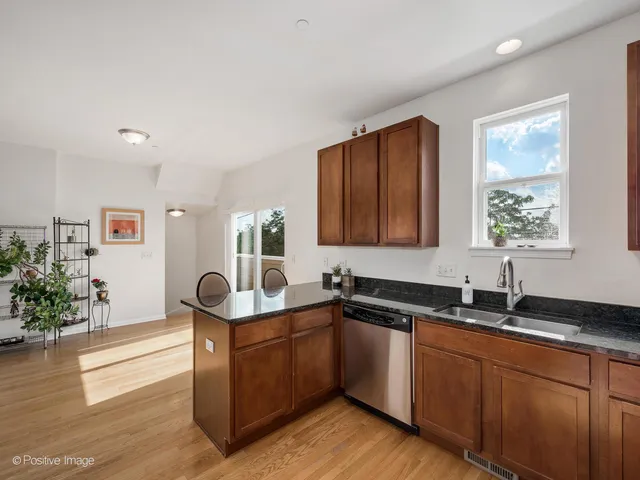 a kitchen with granite countertop a sink and cabinets