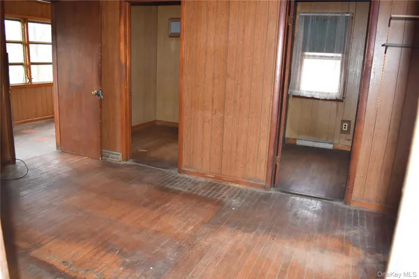 an empty room with windows and entrance