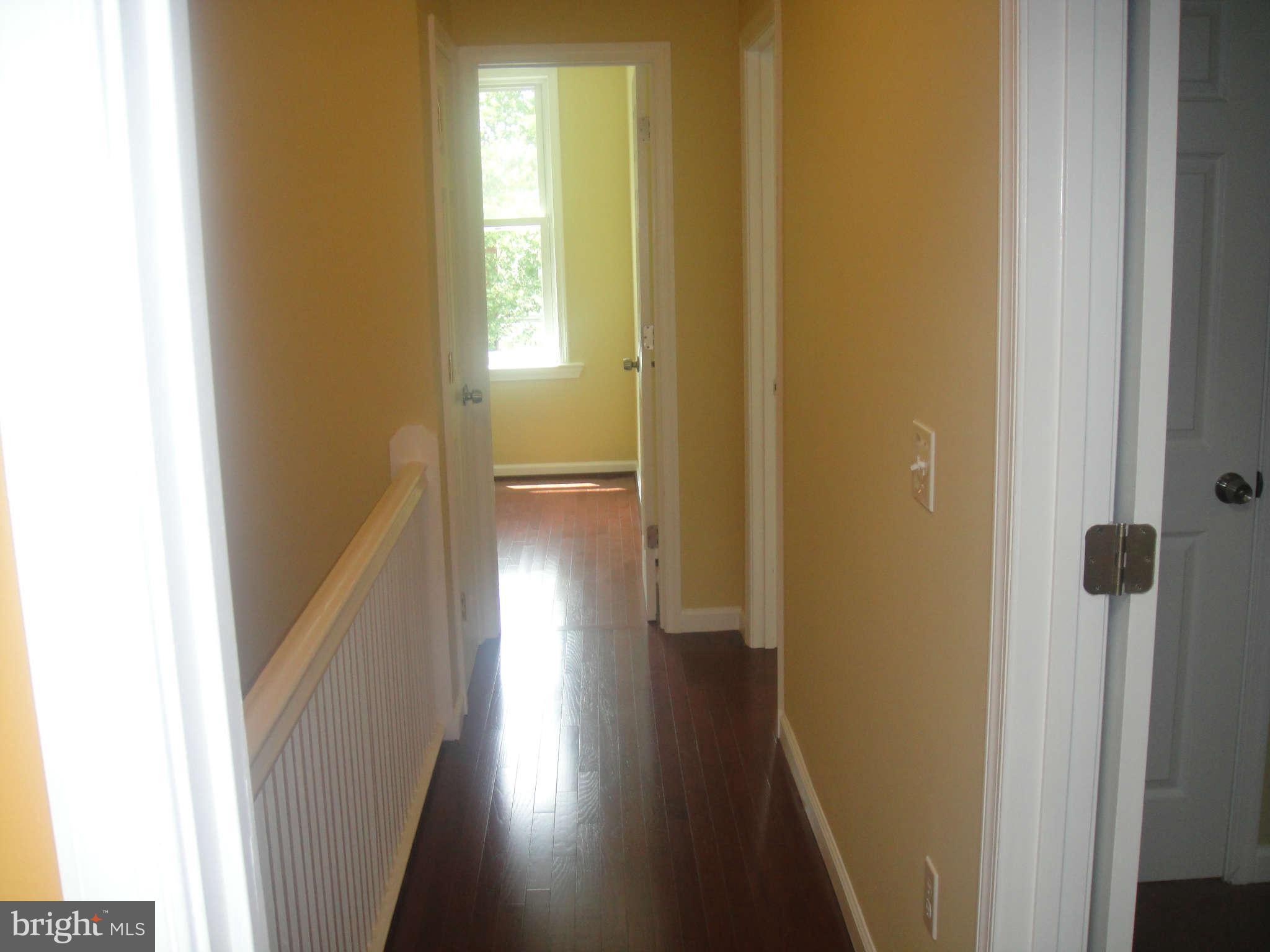 625 Columbia Road Northwest Washington, DC 20001 - Photo 14 of 26 a view of a hallway with wooden floor