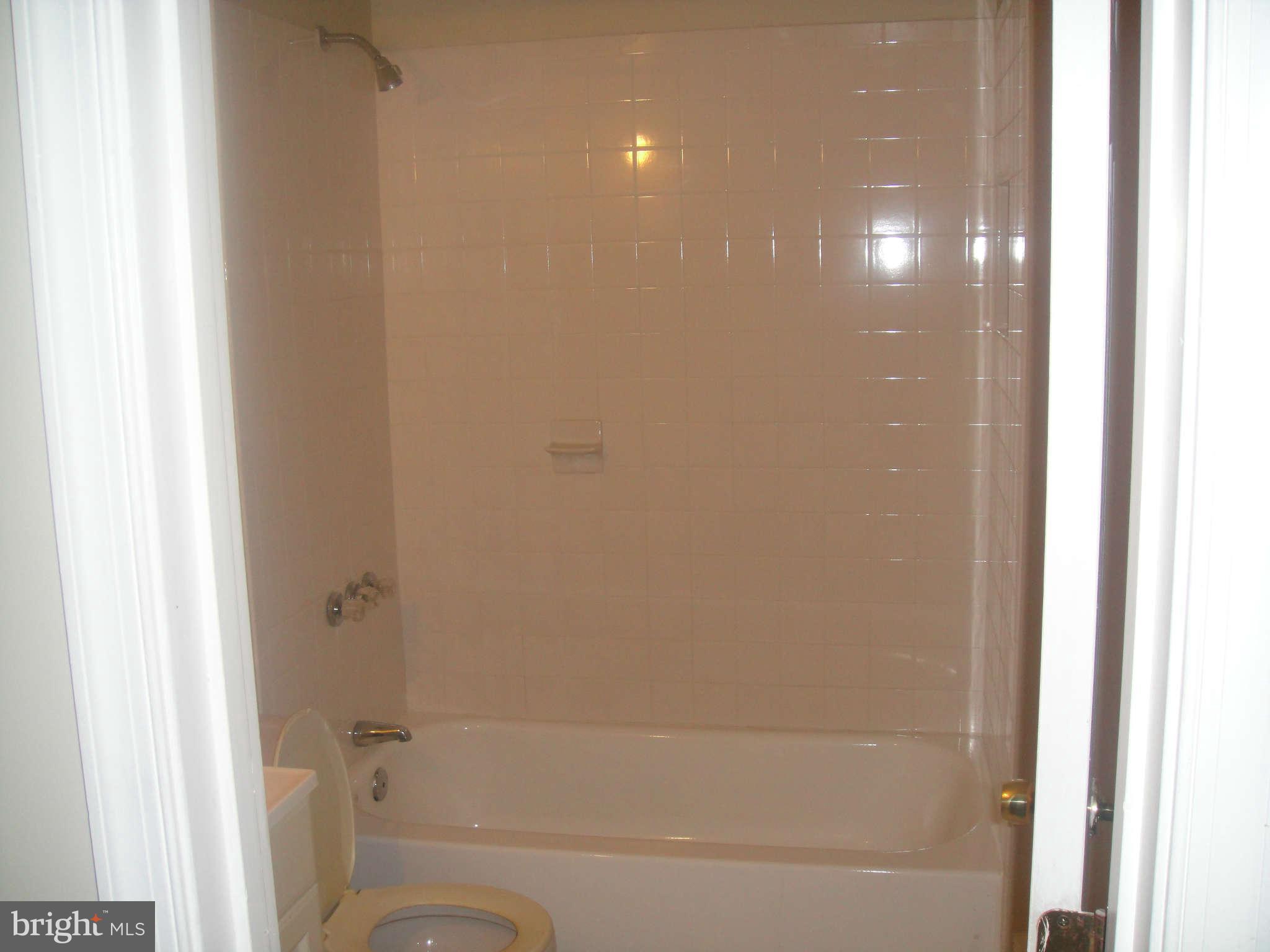 625 Columbia Road Northwest Washington, DC 20001 - Photo 19 of 26 a bathroom with a bathtub and a shower