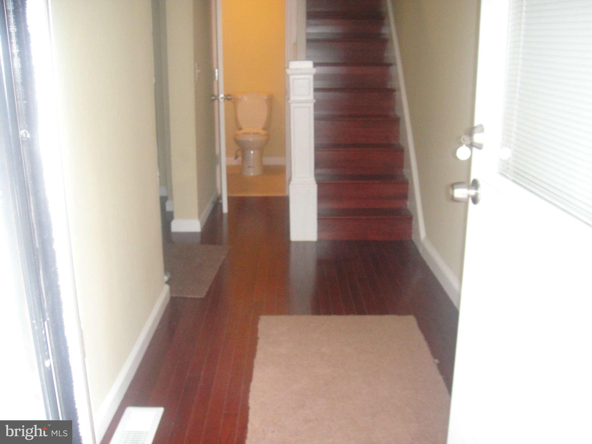 625 Columbia Road Northwest Washington, DC 20001 - Photo 4 of 26 a view of a hallway with wooden floor