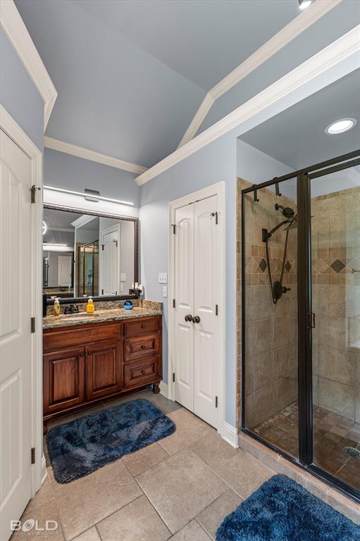 2220 Forest Hills Boulevard Haughton, LA 71037 - Photo 29 of 40 Spacious bathroom featuring a glass-enclosed shower with tile surround, a dark wood vanity with a stone countertop, and large format tile flooring