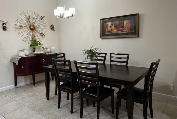 a view of a dining room with furniture and chandelier