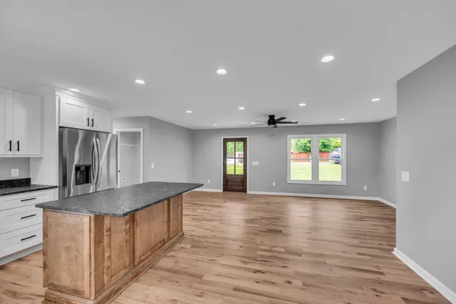 a view of kitchen with stainless steel appliances granite countertop refrigerator sink and microwave