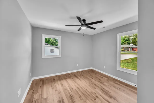 an empty room with windows and closet