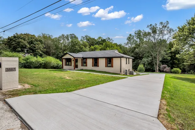 a front view of house with yard and green space