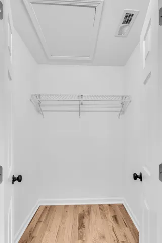 a view of a room with wooden floor