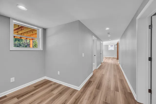 a view of a hallway with wooden floor