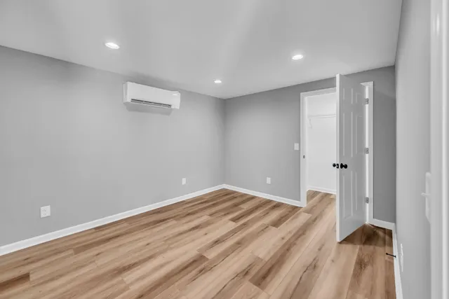 a view of an empty room and wooden floor