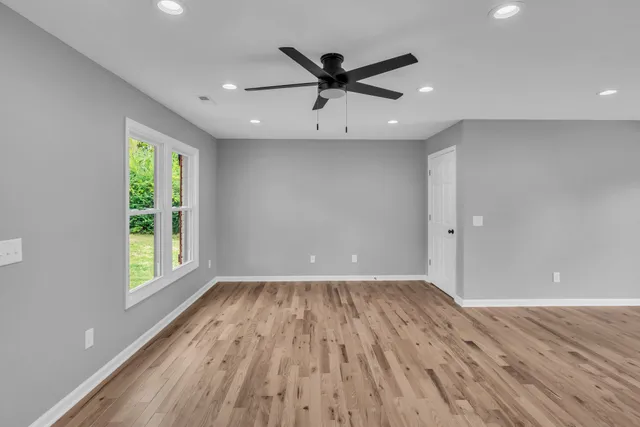 wooden floor in an empty room with a window