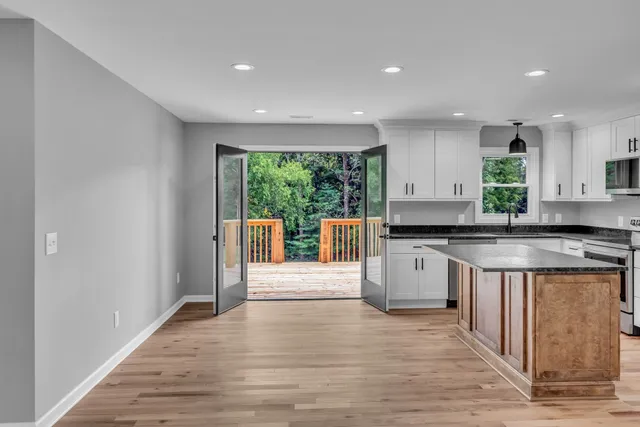 a kitchen with stainless steel appliances granite countertop a stove a sink and a refrigerator