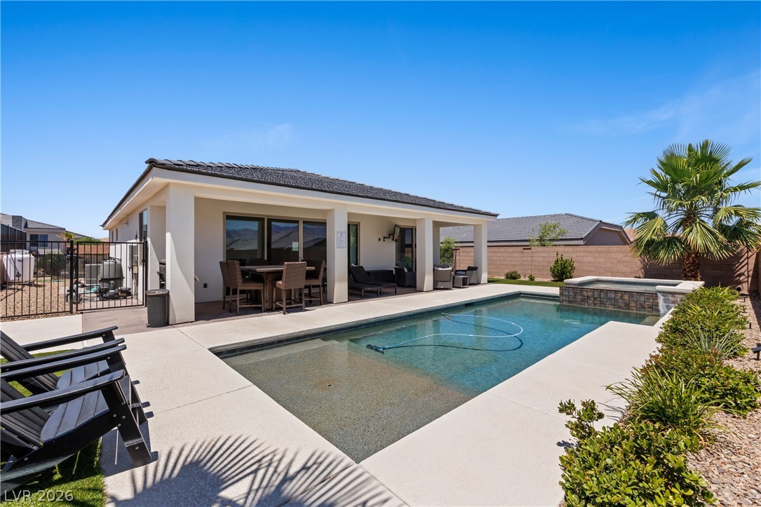 1436 Manassas Ridge Mesquite, NV 89027 - Photo 57 of 77 A private backyard oasis features a glistening pool and a relaxing spa, perfect for entertaining.